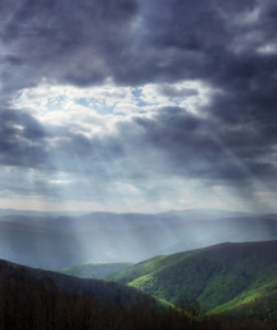 sunlight through dark clouds